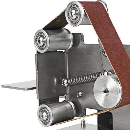 Close-up of mini belt sander rollers, spring tensioner, and stainless steel frame.