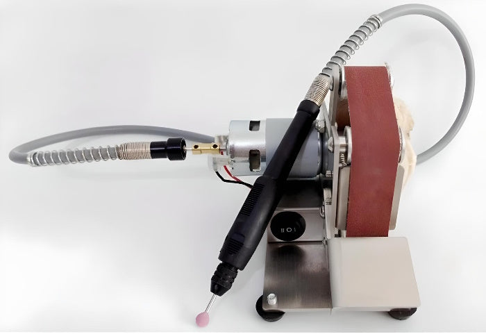 Type 25 mini belt sander with power adapter, belts, and yellow polishing wheel.