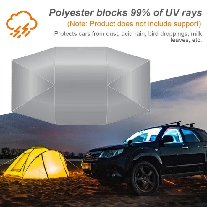 Silver car umbrella protecting a vehicle at night during an outdoor camping trip