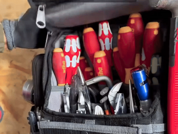 Electric drill stripper peeling insulation to reveal a clean undamaged copper core.