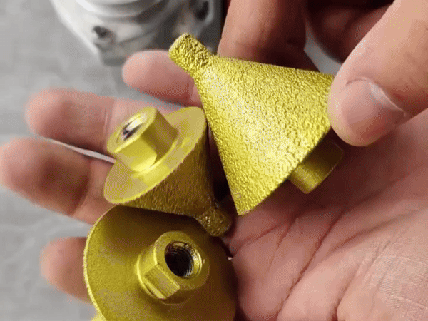 Using a diamond chamfer bit with water cooling on an angle grinder for tile.