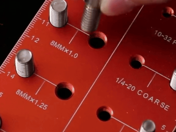 Side view of the thick red aluminum thread checker showing its sturdy construction.