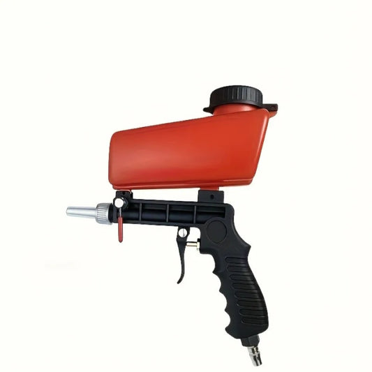 Handheld sandblasting gun removing rust from metal surface at high pressure