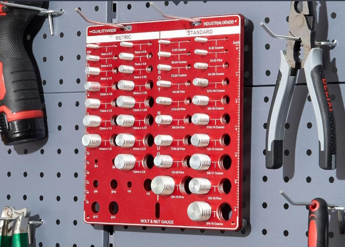 Close-up of permanent laser-etched Metric and SAE scales on a red thread gauge.