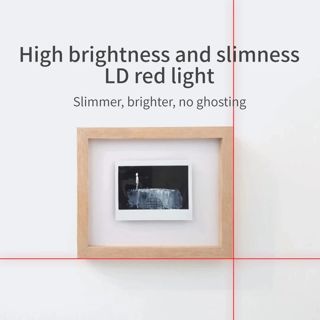 Bright red cross-line laser aligning a picture frame on a white wall.