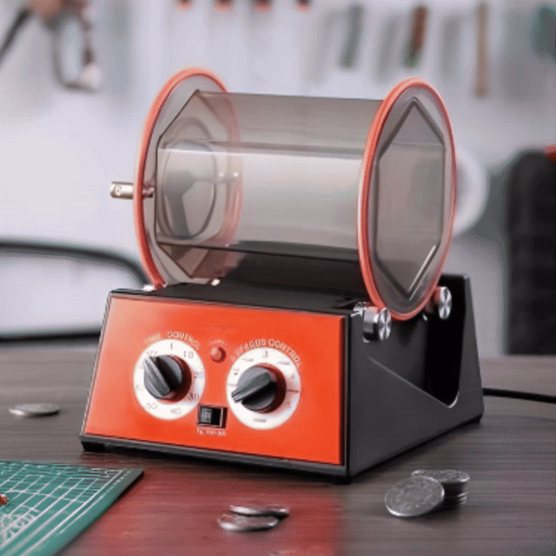 Front view of a rotary jewelry tumbler with polishing media and drive belt.