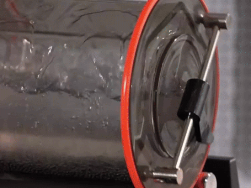 Close-up of the leakproof orange rubber seal on a rotary jewelry tumbler barrel.