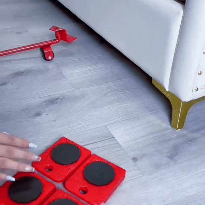 Using a professional furniture lifter to raise a cabinet for roller placement.