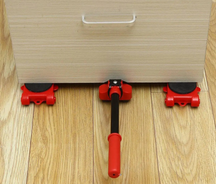 Red 360-degree mover roller positioned securely under a heavy furniture corner.